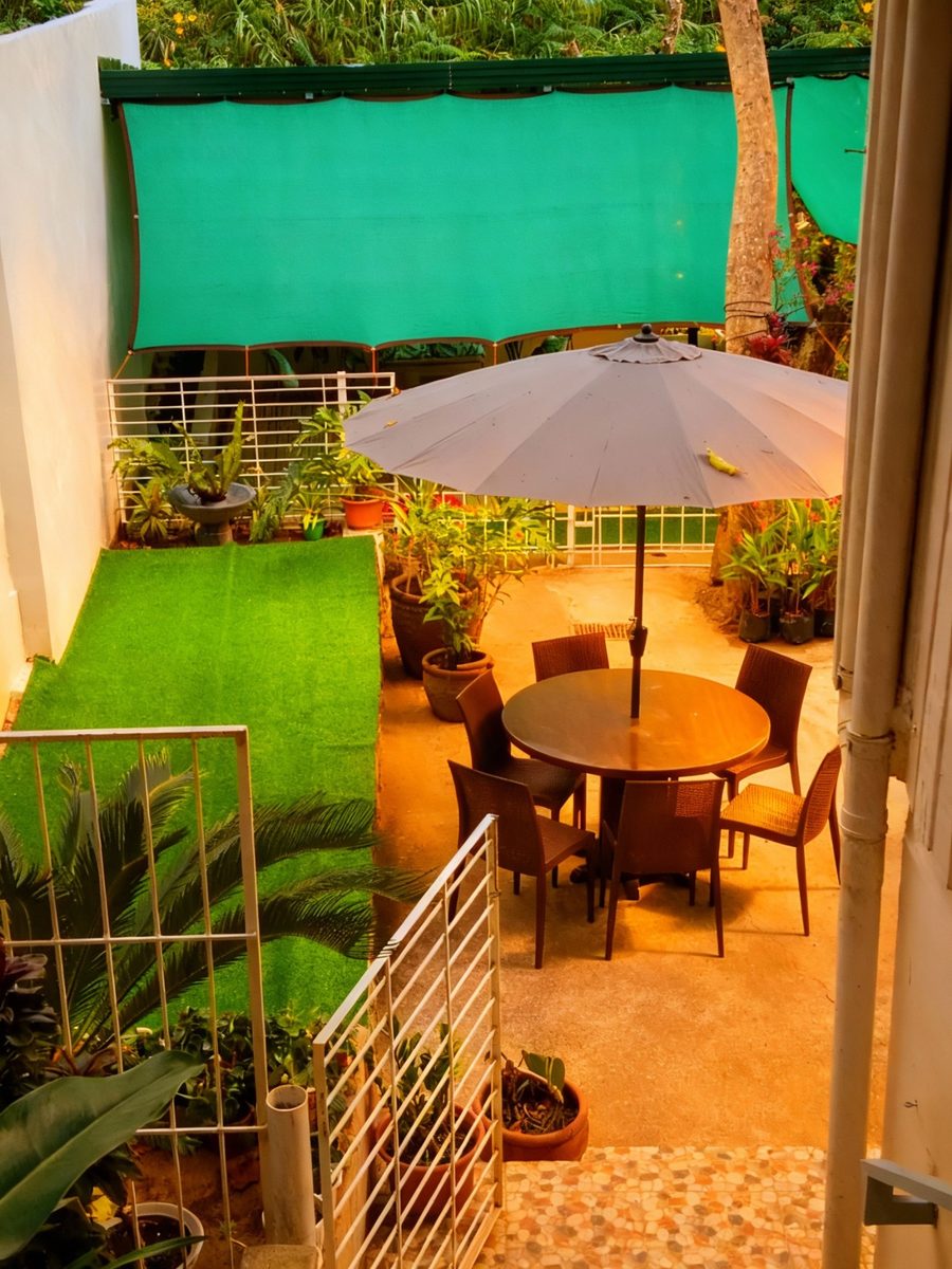 Infront of the Studio Room is a Table with Umbrella